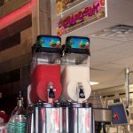 two frozen drink machines at a bar
